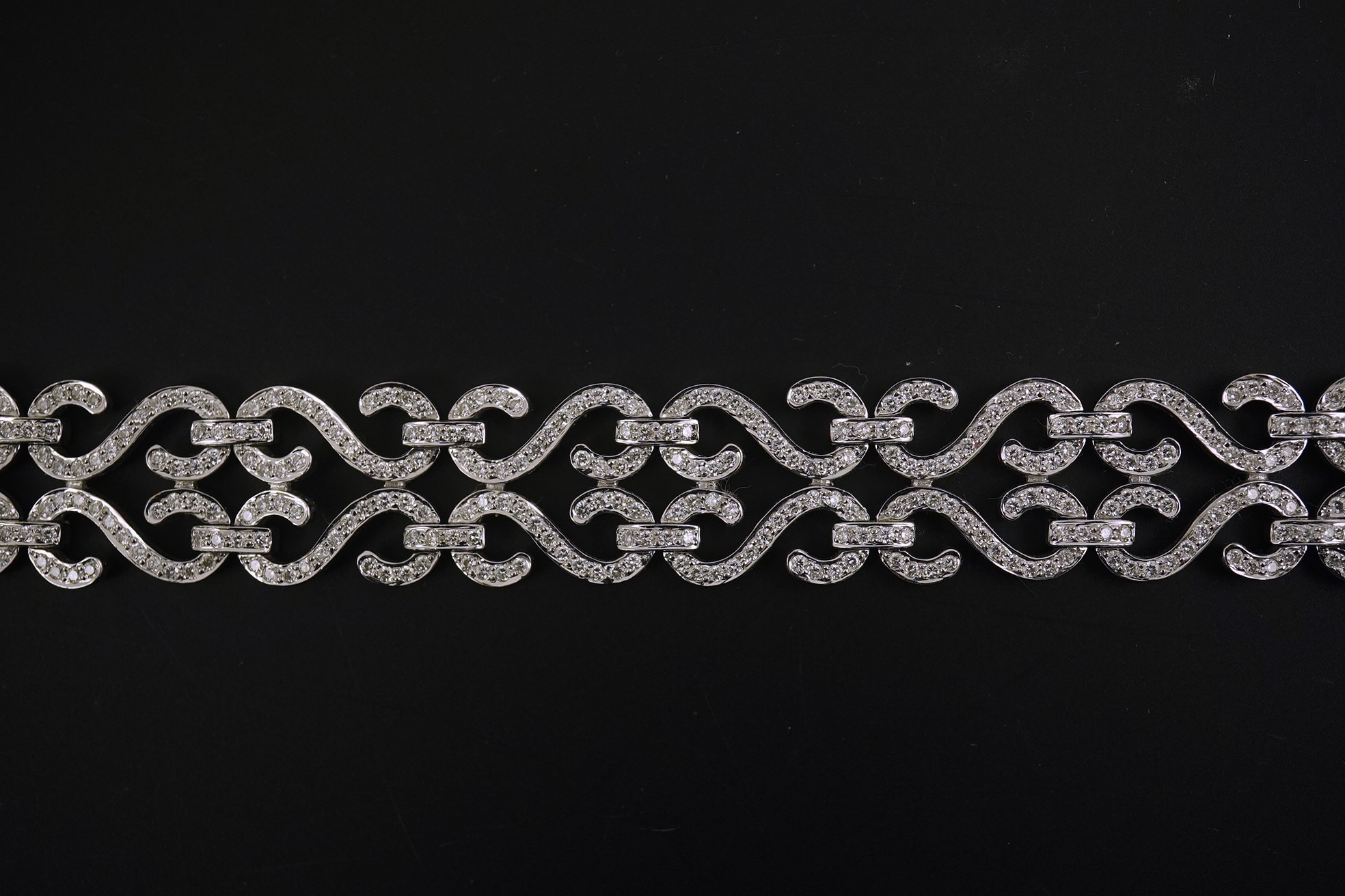 A modern 18k white gold and diamond chip cluster set bracelet